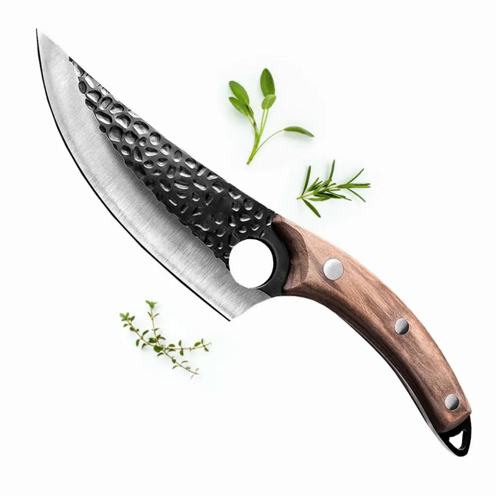 Huusk knife next to leaves