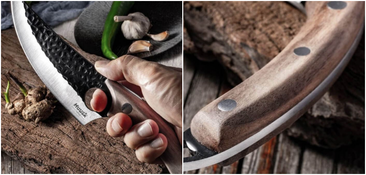 person holds Huusk knife above wooden surface